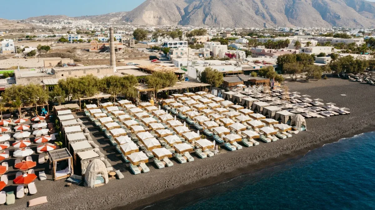 Black-sand loungers and beachfront dining at FortyOne, Perivolos Beach