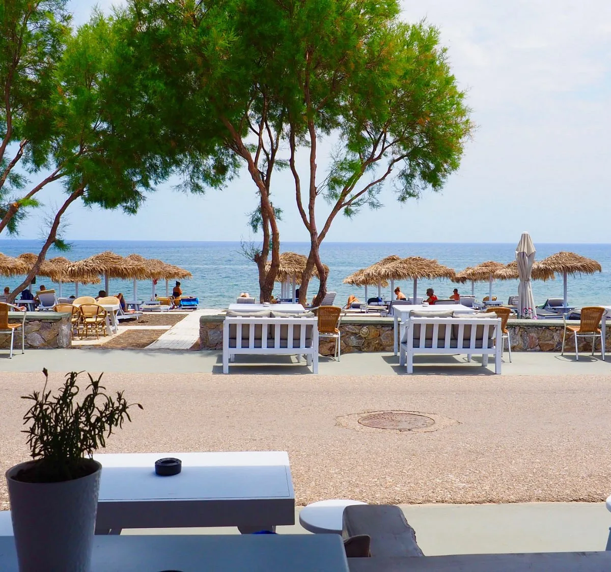 Quiet sunbeds on the black volcanic sand at Waves Chill Out, Perissa Beach