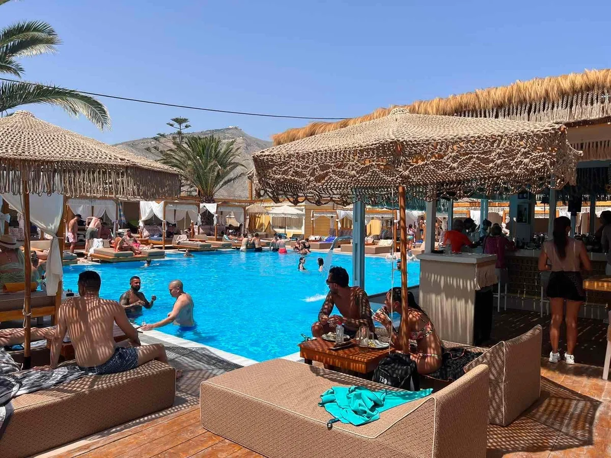 Tiki bar, pool, and Bali beds at Jojo Beach Bar, Perivolos Beach