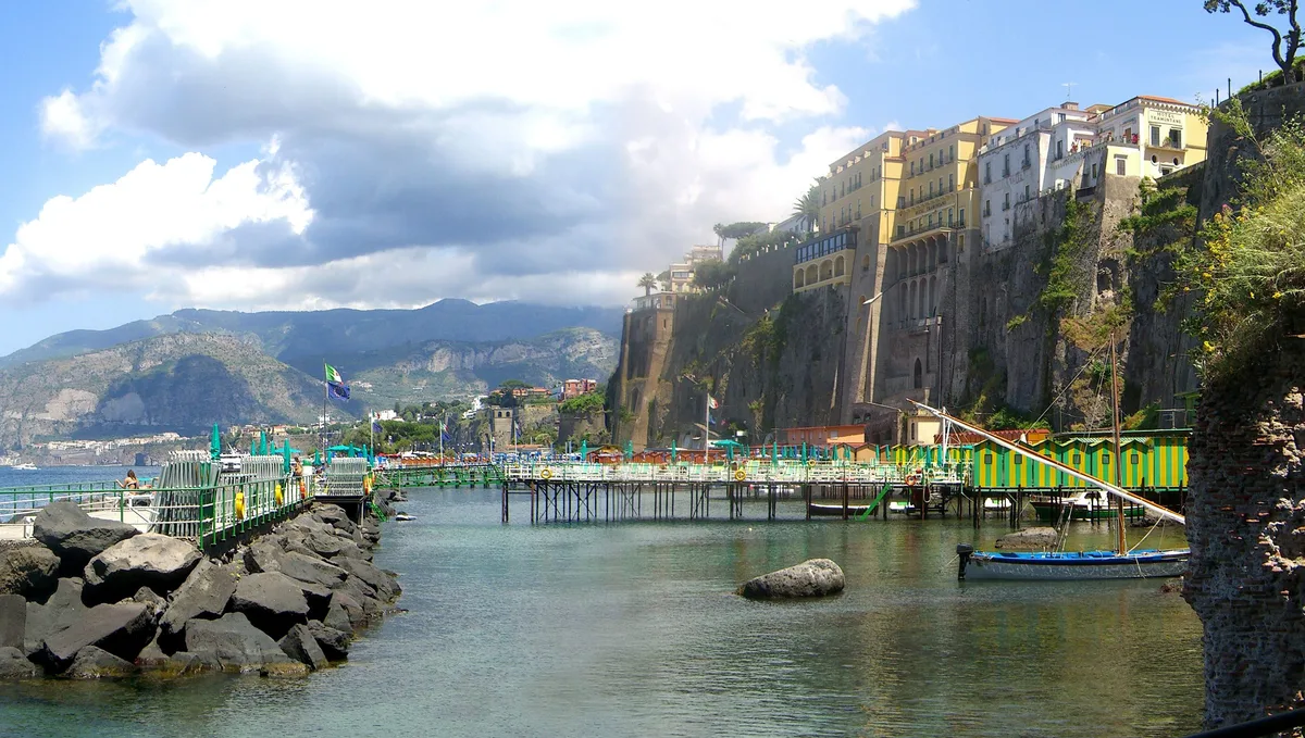 Green and yellow striped piers beside Roman ruins at Bagni Salvatore, Marina Piccola