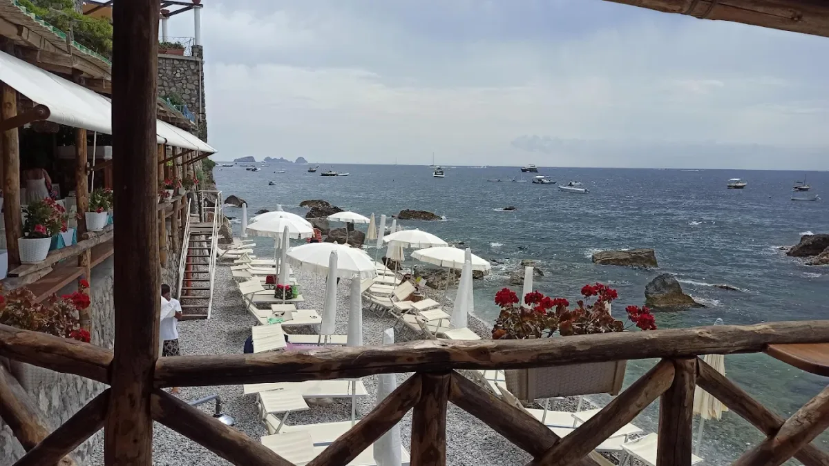 Sunbeds and umbrellas in the Le Mortelle cove at La Perla Nerano, Marina del Cantone