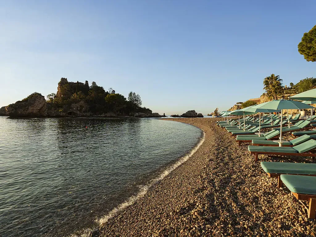 Modern sunbeds and umbrellas at La Plage Resort Beach Club, Isola Bella