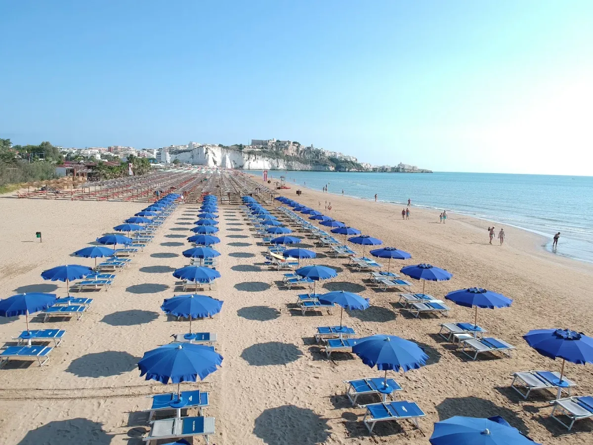 Sunbeds and lounge bar under the monolith at Pizzomunno Beach Club, Scialara