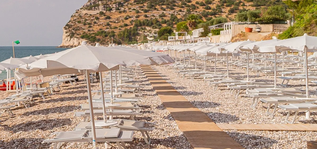 Wood-built lido with sunset aperitivo area at Lido San Matteo, Mattinata bay